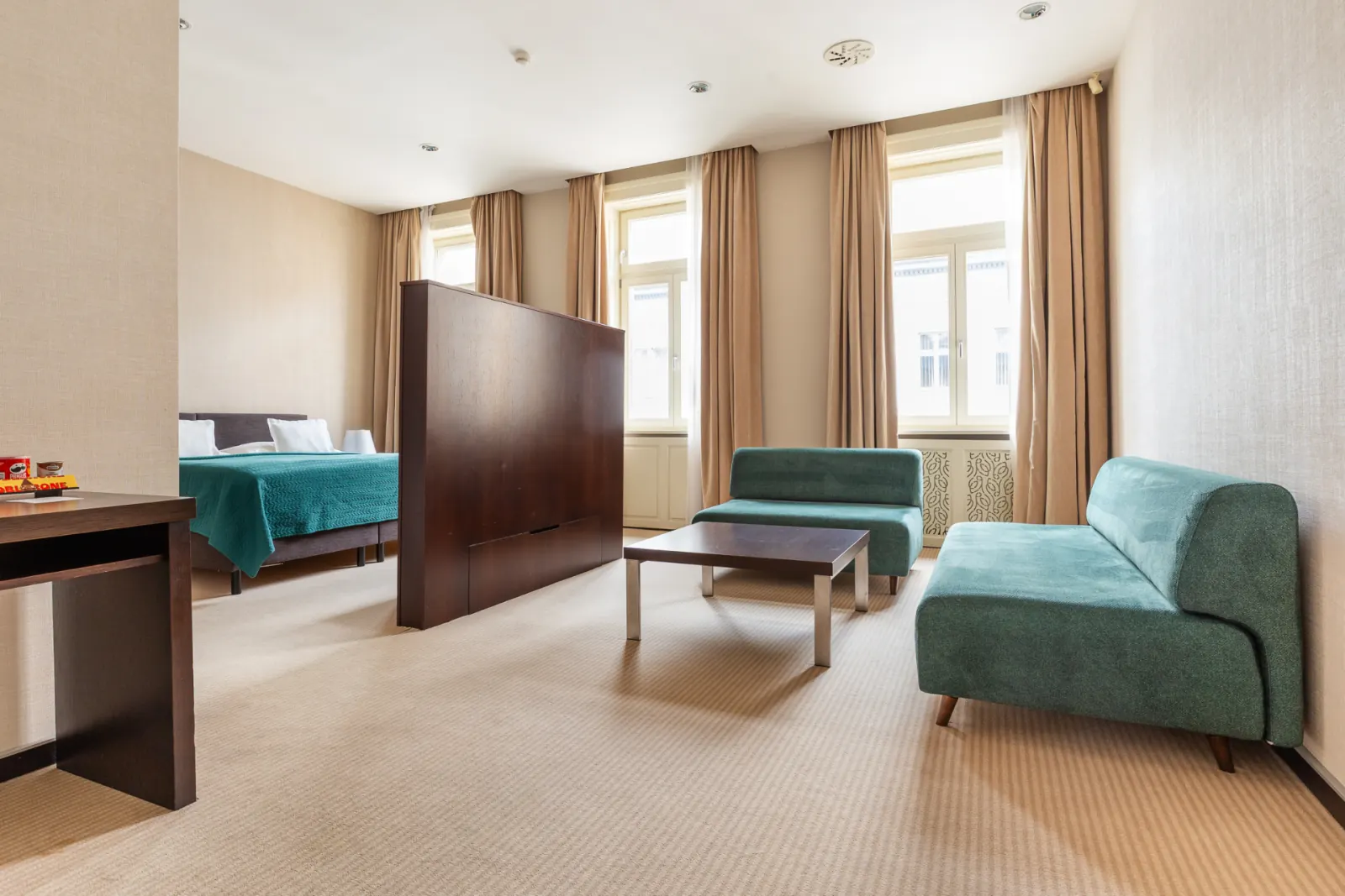 Executive Suite sitting area divided from the bedroom by a wooden partition