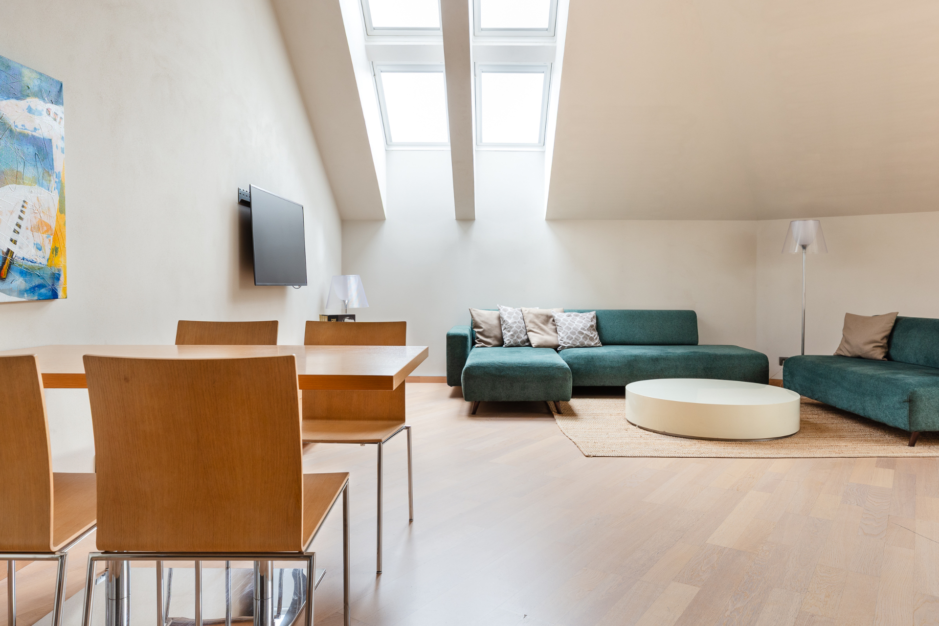 Maisonette upper-floor open-plan living and dining area under twin skylights