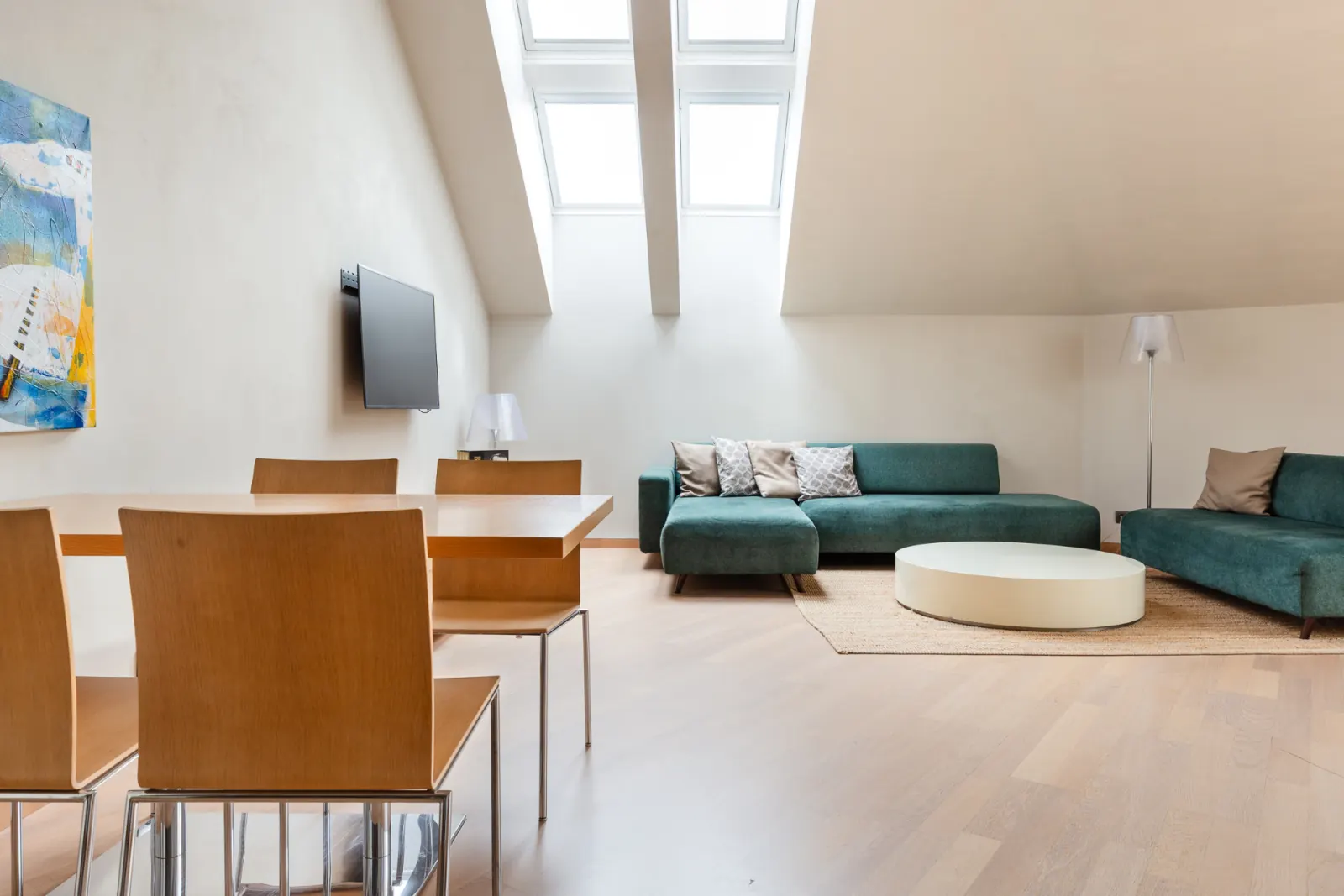 Maisonette upper-floor open-plan living and dining area under twin skylights
